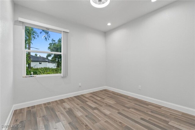 311 Long Ave S, Lehigh Acres, FL 33974 - spare room with wood finished floors and recessed lighting