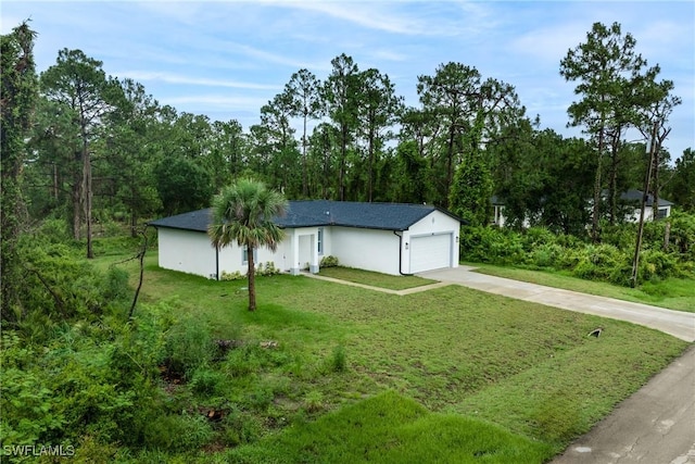 311 Long Ave S, Lehigh Acres, FL 33974 - ranch-style home with concrete driveway, a garage, a front lawn, and stucco siding