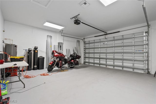 311 Long Ave S, Lehigh Acres, FL 33974 - garage featuring electric water heater, electric panel, and a garage door opener
