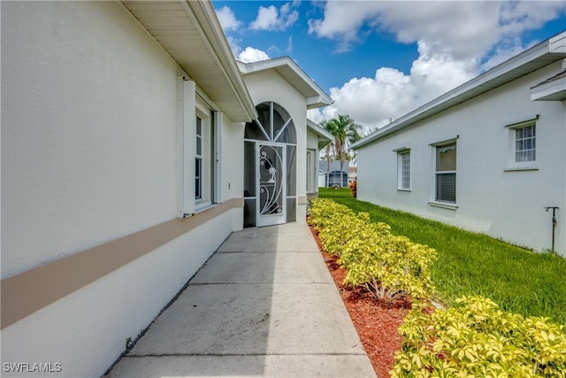 17791 Pineapple Palm Ct, North Fort Myers, FL 33917 - doorway to property featuring stucco siding