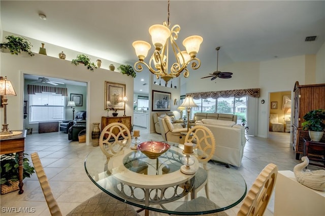 17791 Pineapple Palm Ct, North Fort Myers, FL 33917 - dining space with ceiling fan, a chandelier, a high ceiling, and light tile patterned floors