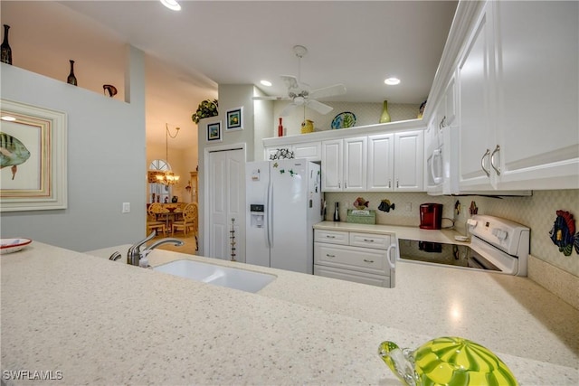 17791 Pineapple Palm Ct, North Fort Myers, FL 33917 - kitchen with white appliances, lofted ceiling, light countertops, white cabinetry, and a ceiling fan