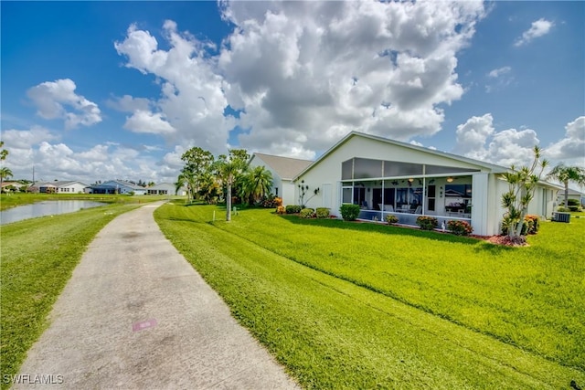 17791 Pineapple Palm Ct, North Fort Myers, FL 33917 - view of front of property with a front yard, a sunroom, a water view, and stucco siding