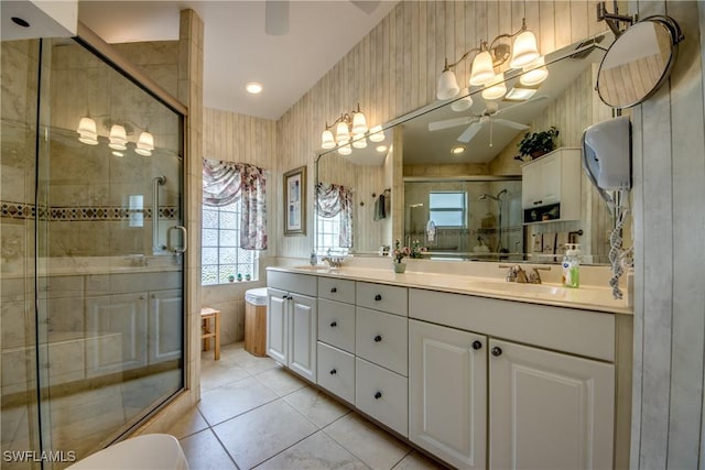 17791 Pineapple Palm Ct, North Fort Myers, FL 33917 - bathroom with ceiling fan, double vanity, a stall shower, and tile patterned flooring