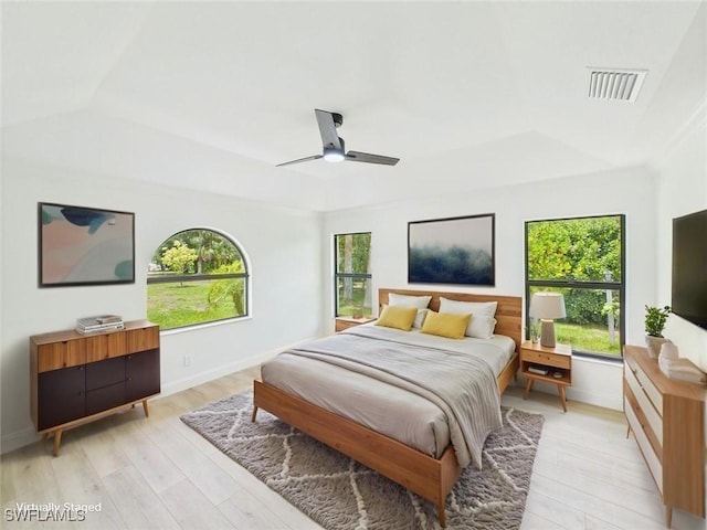 490 25th St SW, Naples, FL 34117 - bedroom featuring a raised ceiling, multiple windows, light wood-type flooring, and ceiling fan