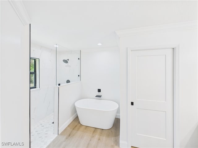 490 25th St SW, Naples, FL 34117 - full bath featuring a marble finish shower, wood finished floors, a freestanding bath, and recessed lighting