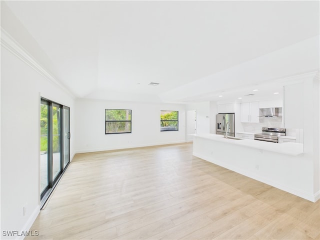 490 25th St SW, Naples, FL 34117 - unfurnished living room featuring plenty of natural light, light wood-style flooring, and recessed lighting