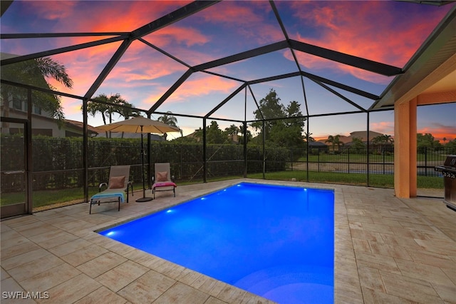 12905 Pastures Way, Fort Myers, FL 33913 - pool at dusk with a patio area and a lanai