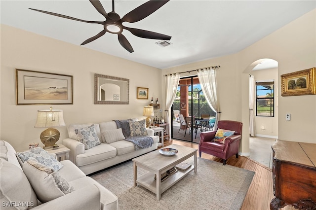 12905 Pastures Way, Fort Myers, FL 33913 - living room with arched walkways, a ceiling fan, and wood finished floors
