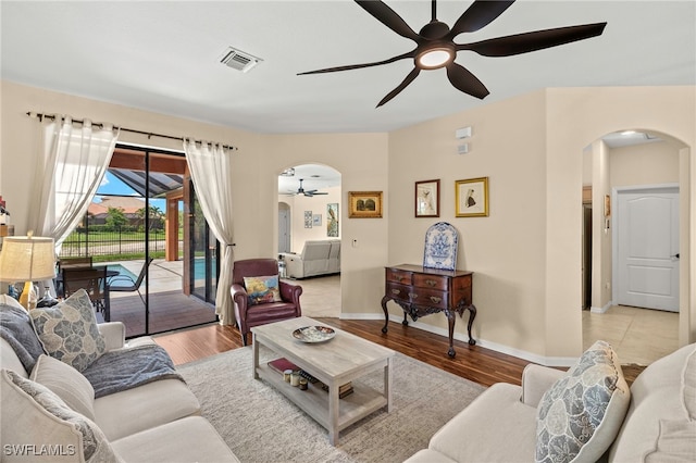 12905 Pastures Way, Fort Myers, FL 33913 - living room with a ceiling fan, arched walkways, and light wood-type flooring