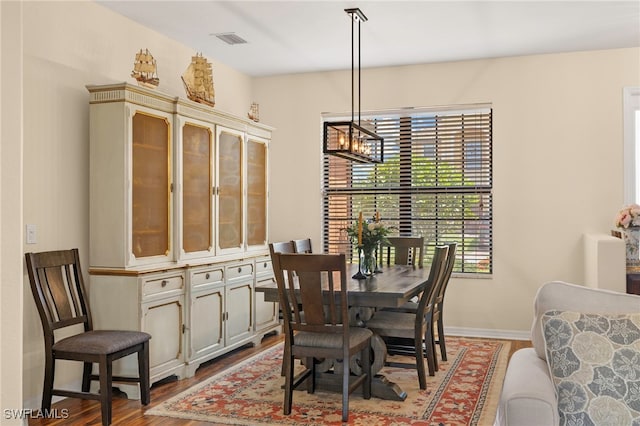 12905 Pastures Way, Fort Myers, FL 33913 - dining area with wood finished floors and a chandelier