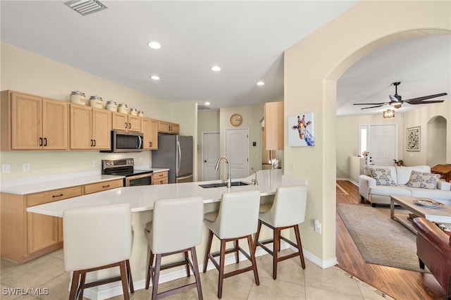 12905 Pastures Way, Fort Myers, FL 33913 - kitchen with appliances with stainless steel finishes, arched walkways, a peninsula, a kitchen breakfast bar, and open floor plan