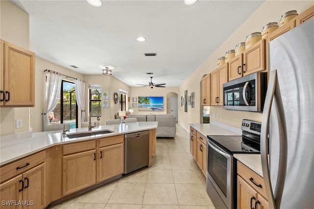 12905 Pastures Way, Fort Myers, FL 33913 - kitchen featuring appliances with stainless steel finishes, a peninsula, open floor plan, ceiling fan, and light countertops