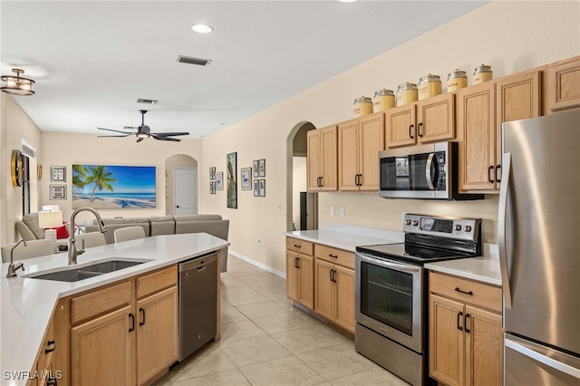 12905 Pastures Way, Fort Myers, FL 33913 - kitchen with appliances with stainless steel finishes, arched walkways, open floor plan, light countertops, and light tile patterned flooring