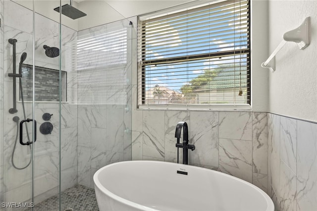 12905 Pastures Way, Fort Myers, FL 33913 - full bathroom with tile walls, a stall shower, and a freestanding bath