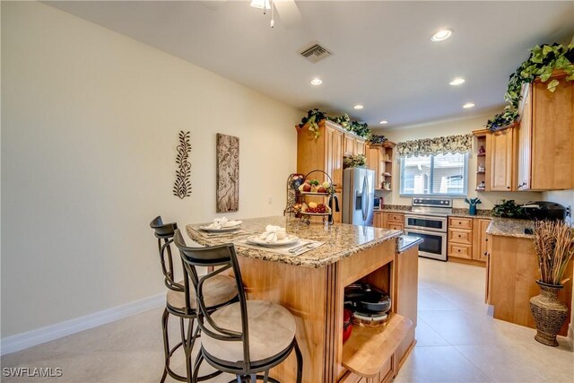 2102 SW 47th St, Cape Coral, FL 33914 - kitchen featuring open shelves, appliances with stainless steel finishes, a peninsula, a kitchen breakfast bar, and recessed lighting