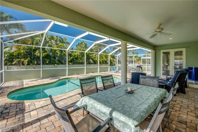 2102 SW 47th St, Cape Coral, FL 33914 - view of patio featuring ceiling fan, a lanai, and outdoor dining space