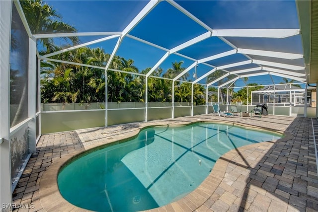 2102 SW 47th St, Cape Coral, FL 33914 - view of swimming pool featuring a patio area and a lanai