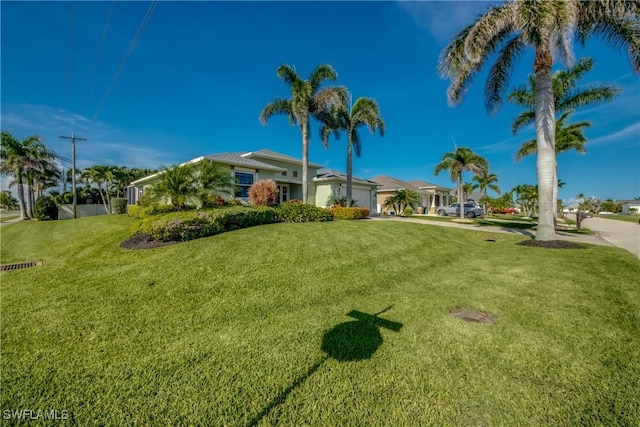 2102 SW 47th St, Cape Coral, FL 33914 - view of front of house featuring an attached garage and a front yard