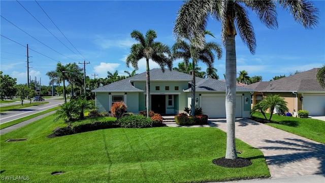 2102 SW 47th St, Cape Coral, FL 33914 - ranch-style house with stucco siding, a garage, decorative driveway, and a front yard