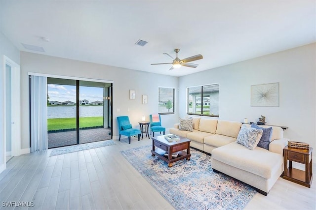 4955 Brigata Way, Ave Maria, FL 34142 - living area featuring a ceiling fan, light wood-type flooring, and a water view