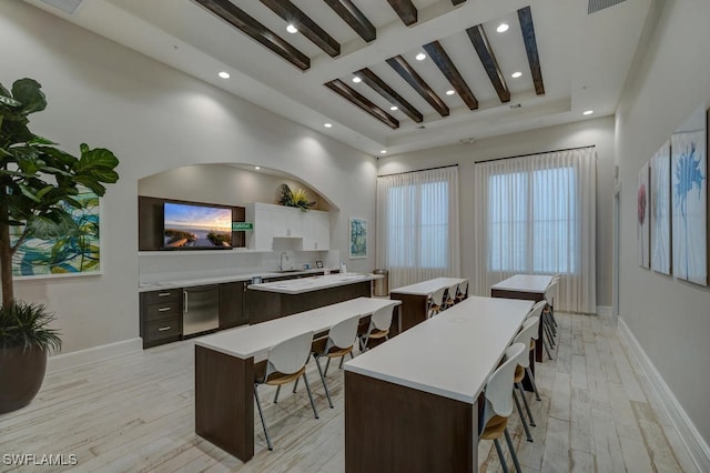 4955 Brigata Way, Ave Maria, FL 34142 - kitchen with a center island, a breakfast bar area, recessed lighting, light countertops, and light wood-style flooring