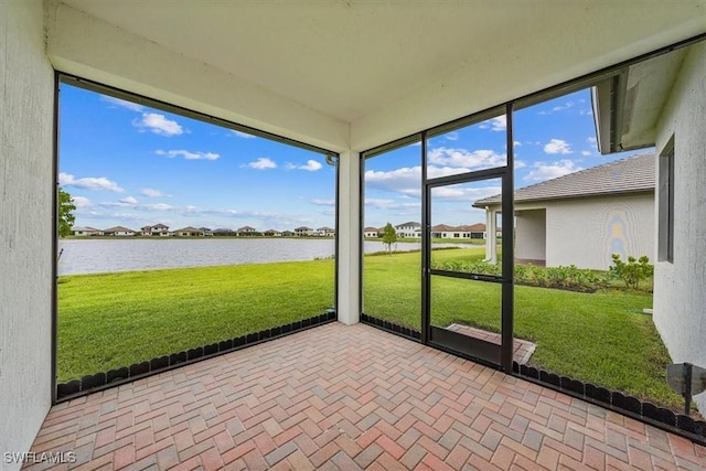 4955 Brigata Way, Ave Maria, FL 34142 - unfurnished sunroom featuring a water view and a residential view