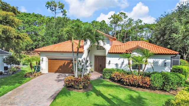 4000 Stonesthrow Ct, Naples, FL 34109 - mediterranean / spanish-style home featuring a tile roof, an attached garage, stucco siding, and decorative driveway