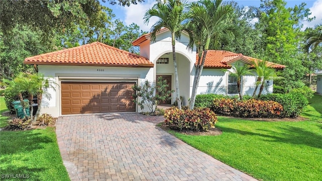 4000 Stonesthrow Ct, Naples, FL 34109 - mediterranean / spanish home with an attached garage, stucco siding, a front yard, and decorative driveway