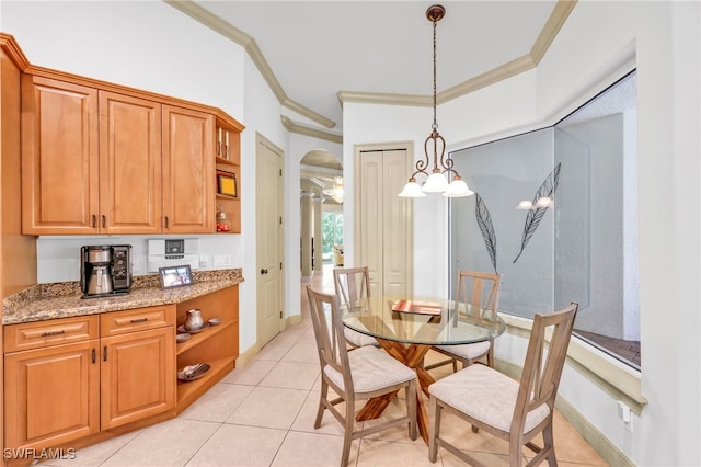 4000 Stonesthrow Ct, Naples, FL 34109 - dining room with arched walkways, light tile patterned floors, and ornamental molding