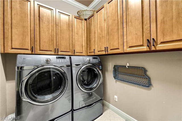 4000 Stonesthrow Ct, Naples, FL 34109 - laundry area featuring crown molding, washer and clothes dryer, cabinet space, and tile patterned flooring