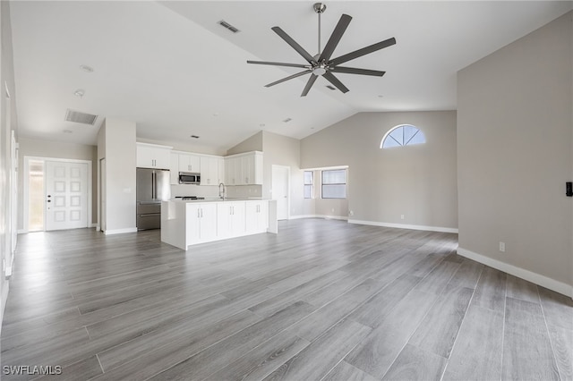 12730 Kelly Palm Dr, Fort Myers, FL 33908 - unfurnished living room with ceiling fan, wood finished floors, and high vaulted ceiling