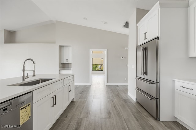 12730 Kelly Palm Dr, Fort Myers, FL 33908 - kitchen with stainless steel appliances, white cabinetry, light countertops, light wood-style flooring, and lofted ceiling