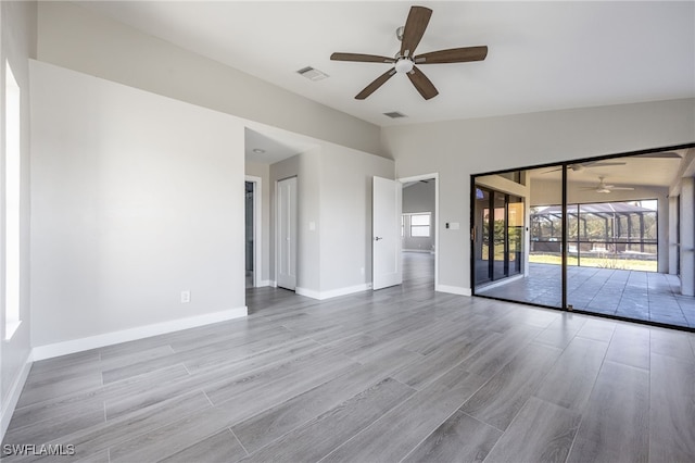 12730 Kelly Palm Dr, Fort Myers, FL 33908 - empty room featuring a ceiling fan, vaulted ceiling, and wood finished floors