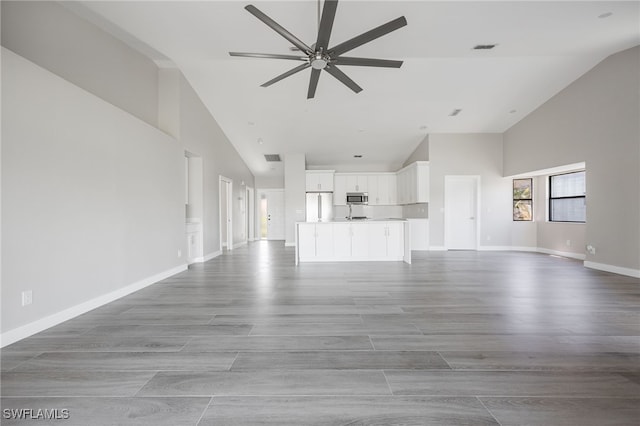 12730 Kelly Palm Dr, Fort Myers, FL 33908 - unfurnished living room featuring high vaulted ceiling, a ceiling fan, and wood finished floors