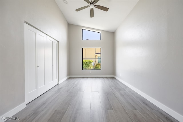12730 Kelly Palm Dr, Fort Myers, FL 33908 - unfurnished bedroom with wood finished floors, high vaulted ceiling, and ceiling fan