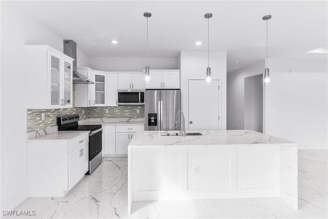 7029 Palpano Cir, Labelle, FL 33935 - kitchen with appliances with stainless steel finishes, wall chimney range hood, tasteful backsplash, light marble finish floors, and recessed lighting