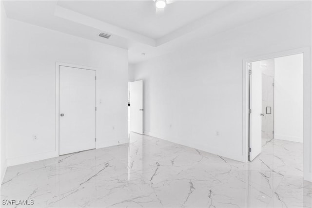 7029 Palpano Cir, Labelle, FL 33935 - unfurnished room with light marble finish floors and a raised ceiling
