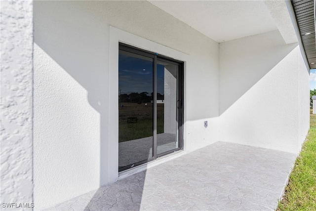7029 Palpano Cir, Labelle, FL 33935 - entrance to property featuring stucco siding and a patio area