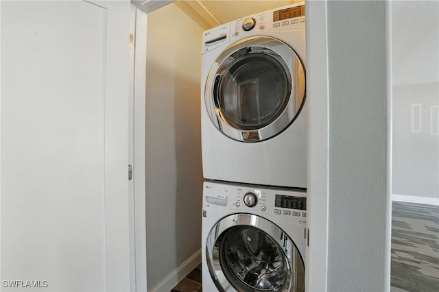 5557 Estero Blvd, Fort Myers Beach, FL 33931 - washroom with stacked washer and clothes dryer and baseboards