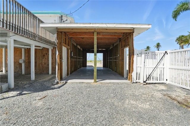 5557 Estero Blvd, Fort Myers Beach, FL 33931 - view of parking / parking lot with an exterior structure, a carport, and gravel driveway