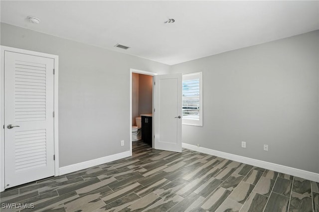 5557 Estero Blvd, Fort Myers Beach, FL 33931 - unfurnished bedroom with wood finish floors and ensuite bath