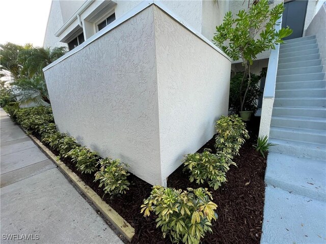3052 Kings Lake Blvd Unit 7554, Naples, FL 34112 - view of home's exterior featuring stucco siding and stairway