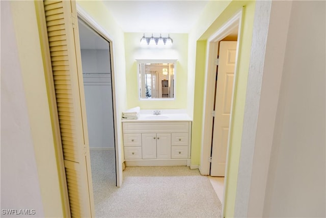 3052 Kings Lake Blvd Unit 7554, Naples, FL 34112 - corridor with light carpet and a sink