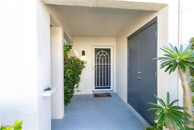 3052 Kings Lake Blvd Unit 7554, Naples, FL 34112 - property entrance featuring stucco siding