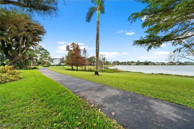 3052 Kings Lake Blvd Unit 7554, Naples, FL 34112 - view of property's community featuring a water view and a yard