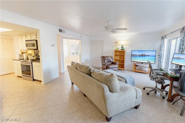 3052 Kings Lake Blvd Unit 7554, Naples, FL 34112 - living room featuring ceiling fan and light tile patterned floors