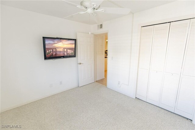 3052 Kings Lake Blvd Unit 7554, Naples, FL 34112 - unfurnished bedroom with carpet, a closet, and a ceiling fan