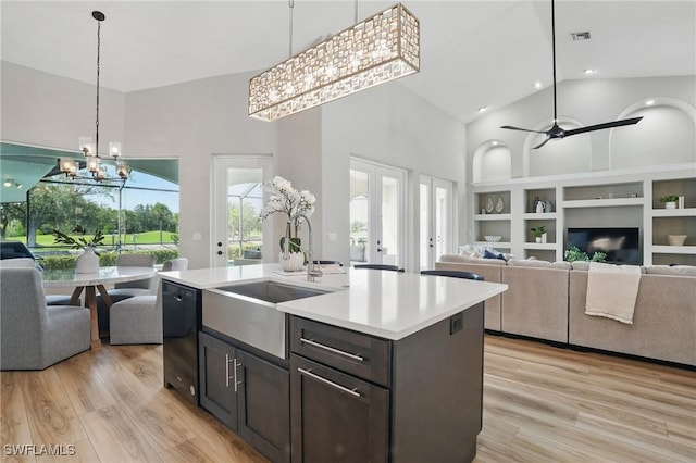 12006 Cypress Links Dr, Fort Myers, FL 33913 - kitchen featuring high vaulted ceiling, open floor plan, a chandelier, light countertops, and light wood-style flooring