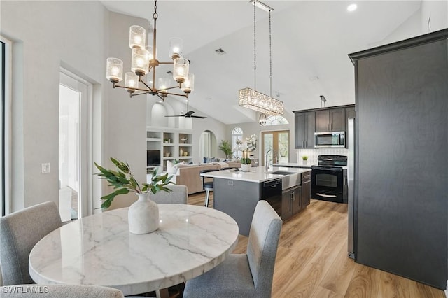 12006 Cypress Links Dr, Fort Myers, FL 33913 - dining area featuring a chandelier, high vaulted ceiling, light wood-type flooring, arched walkways, and a ceiling fan